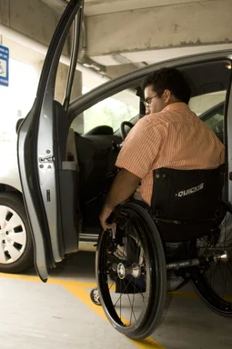 Free Stock Photo: A disabled man in a wheelchair getting out of a car