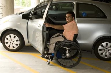 Free Stock Photo: A disabled man in a wheelchair getting out of a car