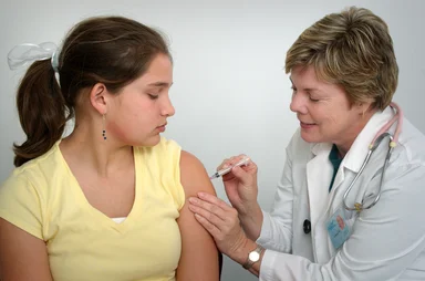 Free Stock Photo: A nurse giving a young girl a vaccine shot