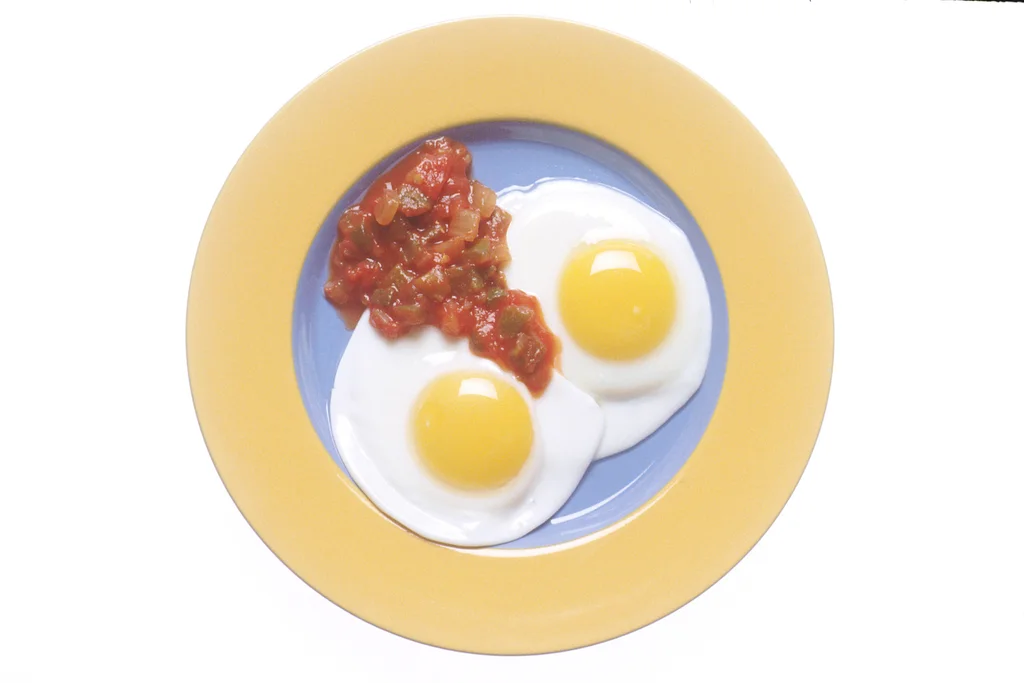 A plate with fried eggs and salsa : Free Stock Photo