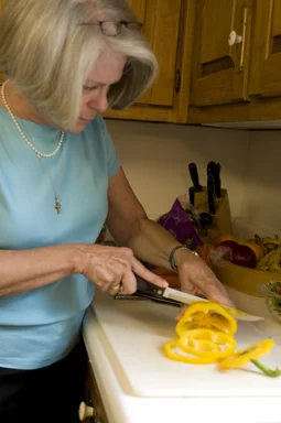 Free Stock Photo: A woman preparing a salad in her kitchen