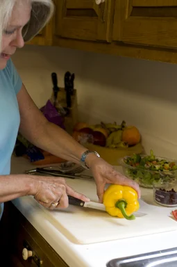 Free Stock Photo: A woman preparing a salad in her kitchen