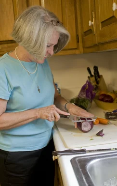Free Stock Photo: A woman preparing a salad in her kitchen