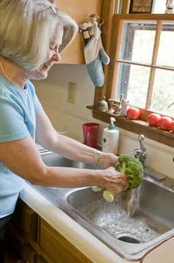 Free Stock Photo: A woman preparing a salad in her kitchen
