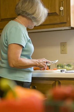 Free Stock Photo: A woman preparing a salad in her kitchen