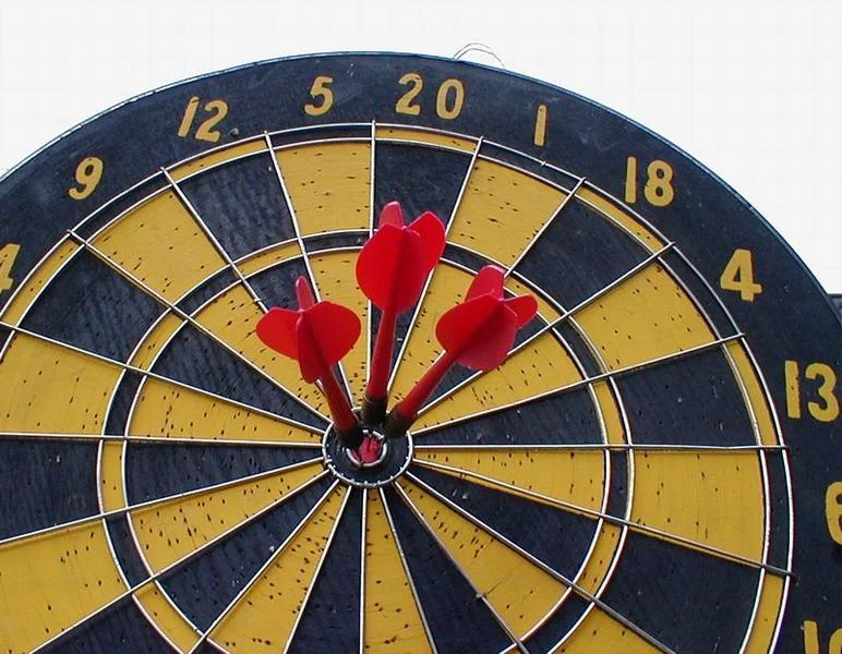 Dartboard with three darts in bullseye : Free Stock Photo