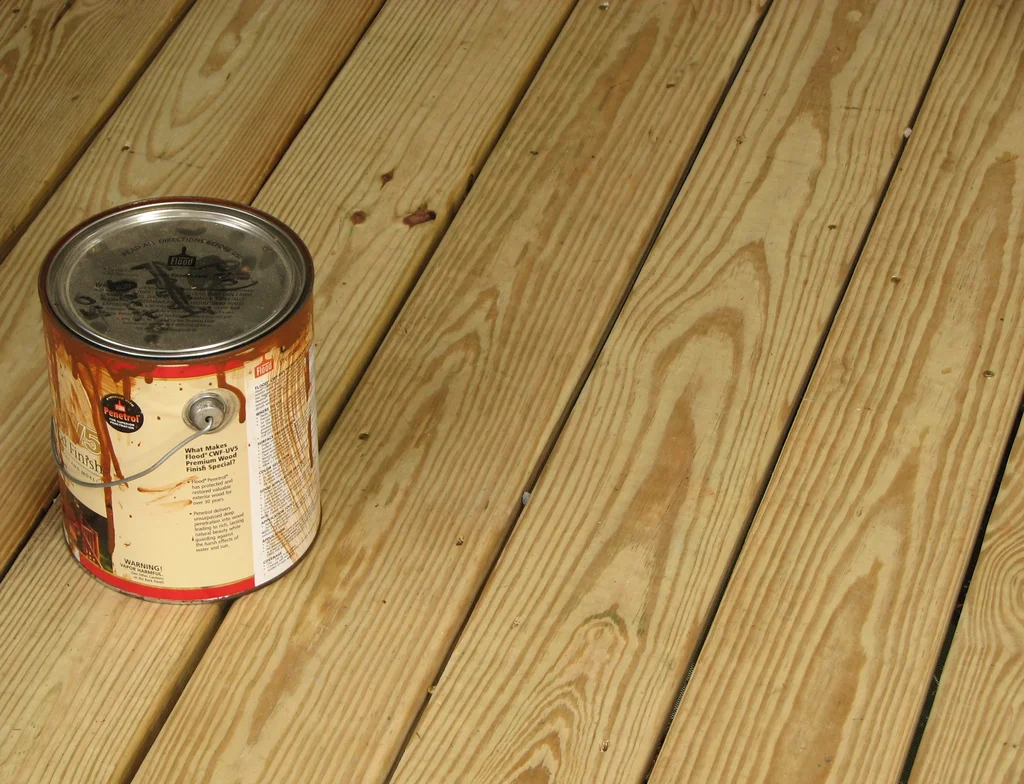 Can of wood stain on a wooden deck : Free Stock Photo