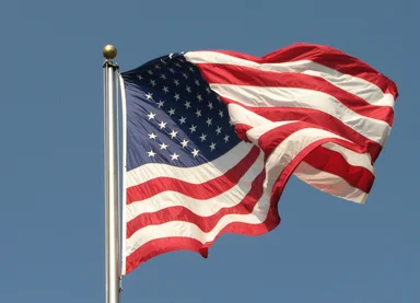 Free Stock Photo: US flag flying in a blue sky