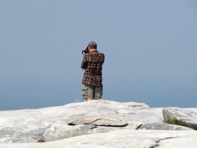 Free Stock Photo: Tourist taking a picture from the top of Stone Mountain
