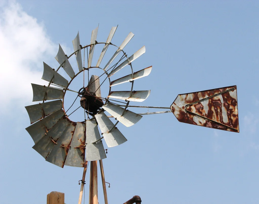 An old farm windmill in a blue sky : Free Stock Photo