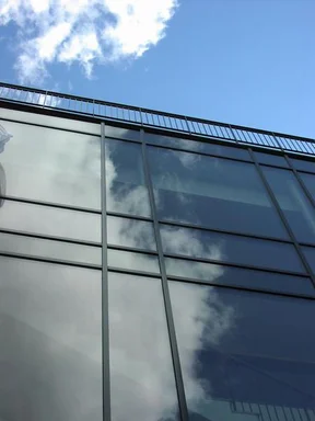 Free Stock Photo: Closeup of glass building with blue sky