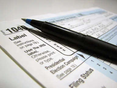 Free Stock Photo: Closeup of a 1040 tax form and a pen