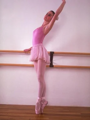 Free Stock Photo: A ballerina in pink practicing on a barre