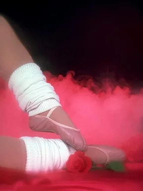Free Stock Photo: Closeup of a ballerina's feet and legs with a red rose