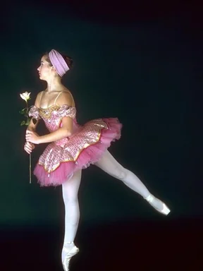 Free Stock Photo: A young ballerina posing with a yellow rose