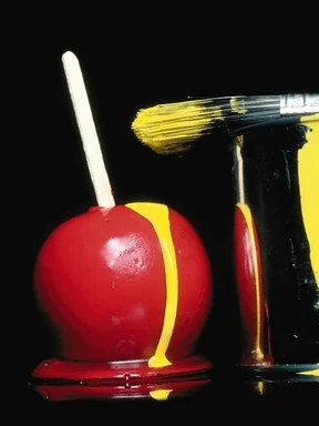 Free Stock Photo: Candy apple with yellow paint dripping on it