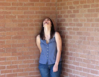Free Stock Photo: Beautiful teen girl laughing in a brick wall corner