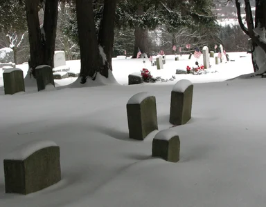 Free Stock Photo: US flags and tombstones in a snow covered graveyard