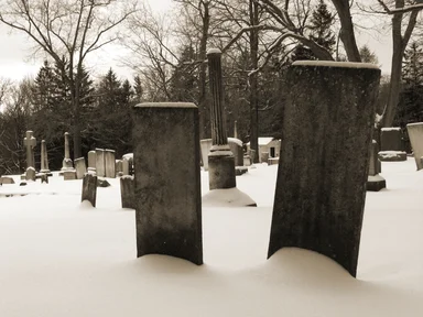 Free Stock Photo: Black and white old tombstones in a snow covered graveyard