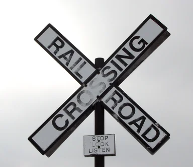 Free Stock Photo: A railroad crossing sign in a cloudy sky
