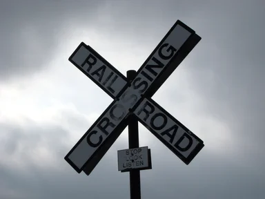 Free Stock Photo: A railroad crossing sign in a cloudy sky
