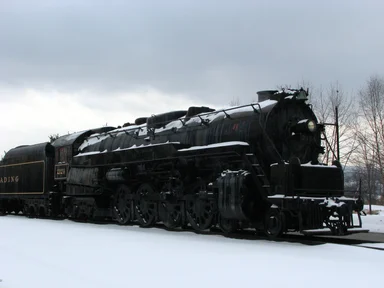 Free Stock Photo: A steam locomotive under a stormy winter sky