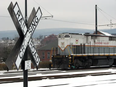 Free Stock Photo: A train passing by a railroad crossing sign