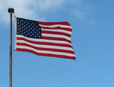 Free Stock Photo: A US flag flying in a blue sky