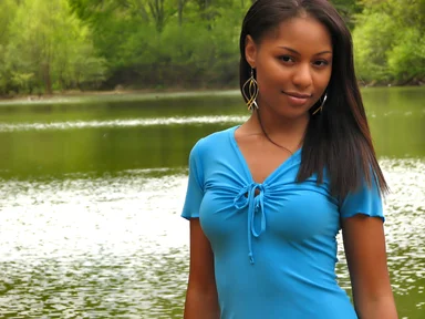Free Stock Photo: A beautiful African American teen girl posing by a lake