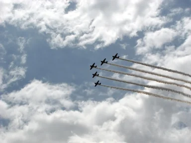 Free Stock Photo: Vintage SNJ-2 WW2 fighter planes flying in formation with smoke trails