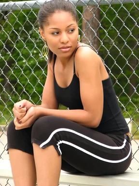 Free Stock Photo: A beautiful teen African American girl sitting on bleachers