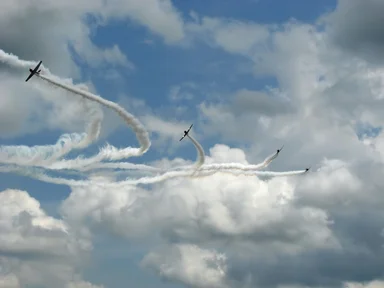 Free Stock Photo: Vintage SNJ-2 WW2 fighter planes flying in formation with smoke trails