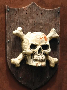 Free Stock Photo: A skull and crossbones pirate plaque on a wall