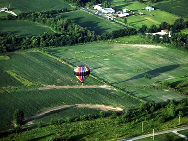 Free Stock Photo: A hot air balloon flying over fields