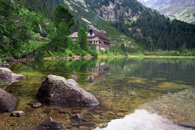 Free Stock Photo: A chalet by a stream at the base of a mountain