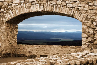 Free Stock Photo: A mountain view through a stone arch