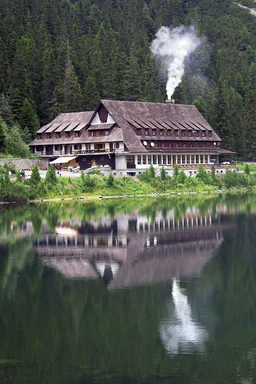 Free Stock Photo: A chalet at the base of a mountain reflecting in water