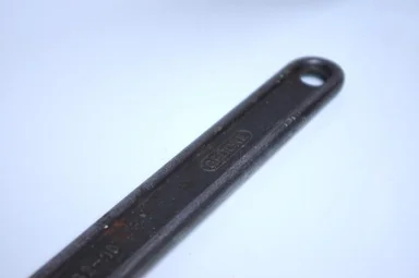 Free Stock Photo: Handle of an adjustable wrench isolated on a white background