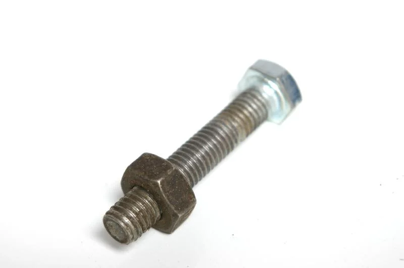 A bolt and nut isolated on a white background : Free Stock Photo