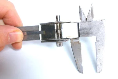 Free Stock Photo: A hand holding a measuring tool isolated on a white background
