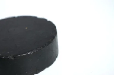 Free Stock Photo: A black hockey puck isolated on a white background