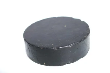 Free Stock Photo: A black hockey puck isolated on a white background