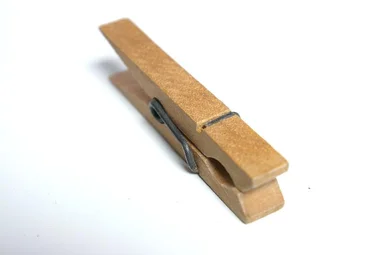 Free Stock Photo: A wooden clothes pin isolated on a white background