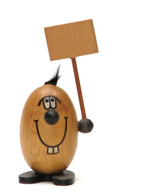 Free Stock Photo: A wooden figure with a blank sign isolated on a white background