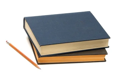 Free Stock Photo: A stack of books and a pencil isolated on a white background
