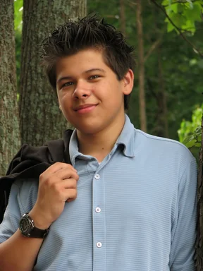 Free Stock Photo: A young latino teen boy posing outdoors by a tree
