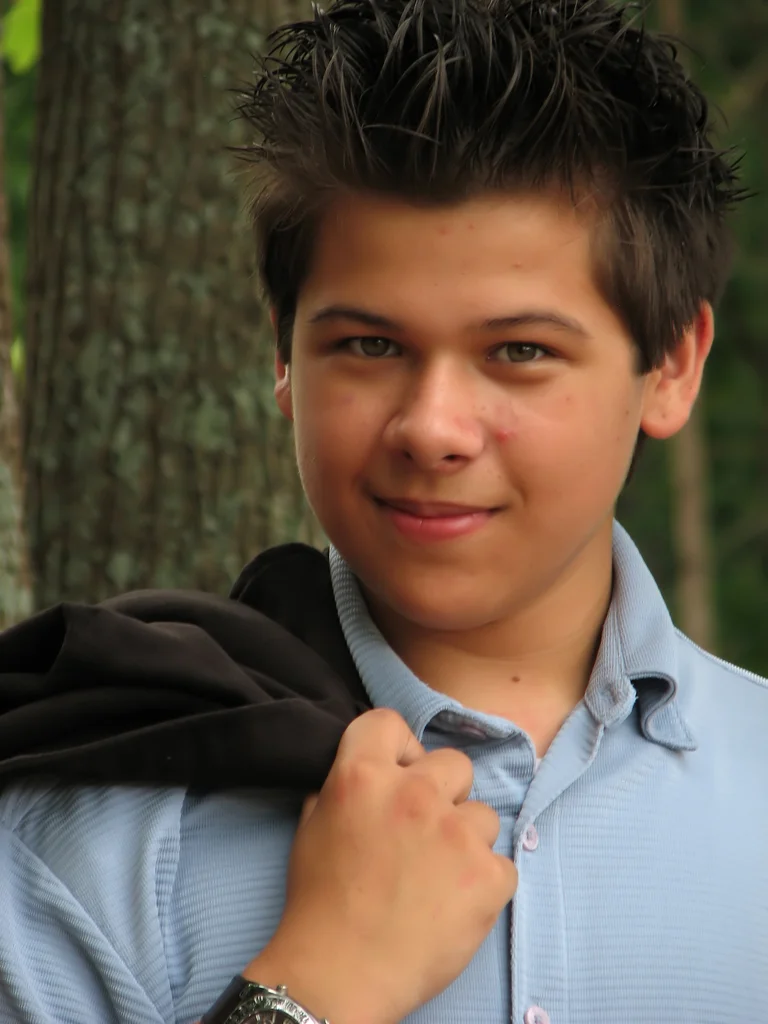 A young latino teen boy posing outdoors by a tree : Free Stock Photo