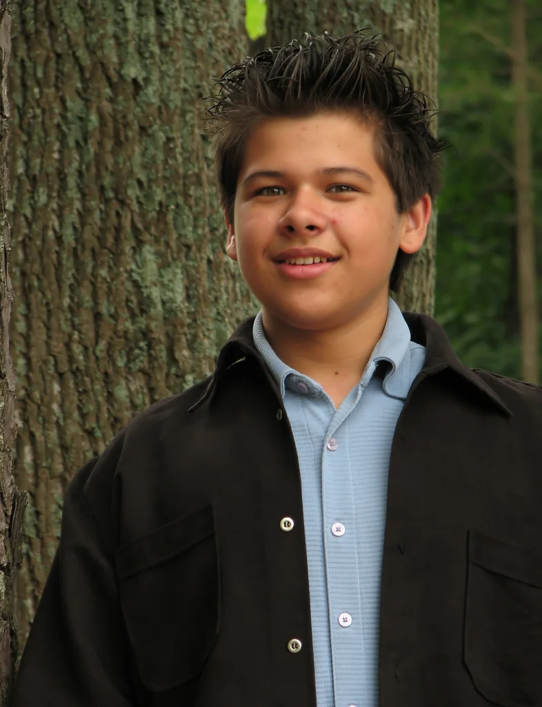 A young latino teen boy posing outdoors by a tree : Free Stock Photo