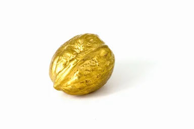 Free Stock Photo: A golden nut isolated on a white background