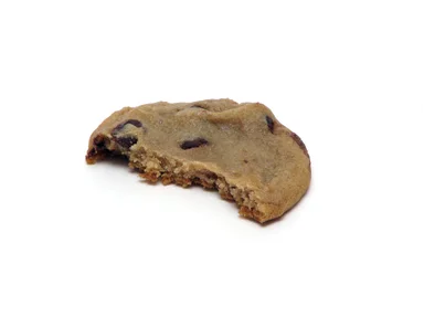 Free Stock Photo: A half eaten chocolate chip cookie isolated on a white background